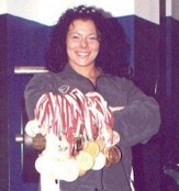 Aneta- The Strongest Female Athlete in Poland showing off her many medals from strength championships.